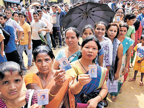 Voters queue to cast their ballots in thefinal phase of the Assamassembly elections at a polling station in Guwahati onMonday. UJJAL DEB