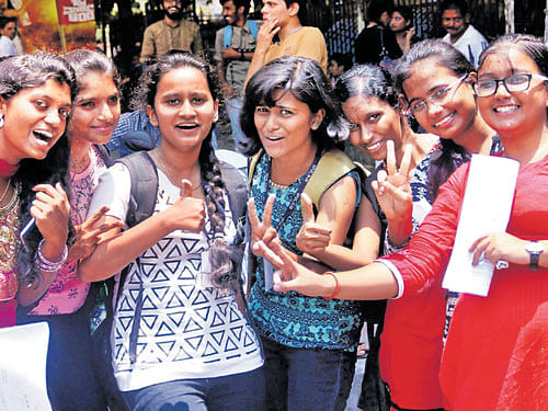 Students are happy after appearing for the second PUC Chemistry re-examination at Sheshadripuram College on Tuesday. DH PHOTO