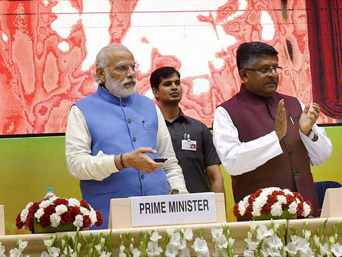 Prime Minister Narendra Modi with and Union Minister for Communications & IT, Ravi Shankar Prasad launches the National Agriculture Market, an e-market, in New Delhi on Thursday. PTI Photo