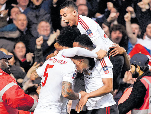 Over the moon: Marouane Fellaini (not seen) celebrates with team-mates after scoring against West Ham. Reuters