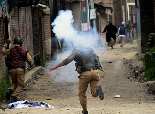 Police in action against the members of Tehreek-e-Hurriyat who were taking out a protest march against the killing of four persons in Handwara, in Srinagar on Friday. PTI Photo
