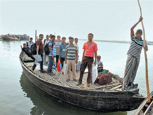 Polling parties leave for election duty by a boat in Malda  district on Saturday. PTI