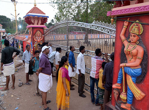 People in front gate of the Puttingal temple complex in Paravoor village, Kollam district on Tuesday. PTI Photo