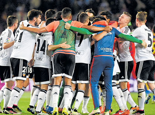 Jubilant: Valencia players celebrate after their win over Barcelona on Sunday. Valencia beat Barca 2-1. Reuters