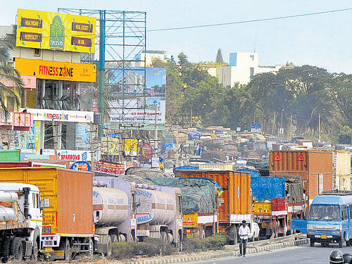 Trucks pile up on Hosur Road during the protest. dh photo