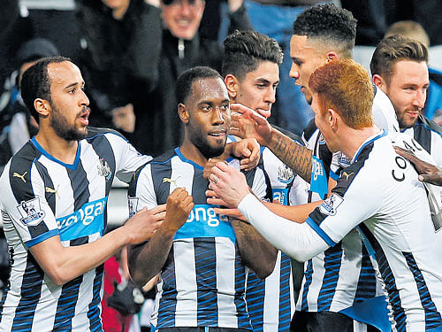 Newcastle United's Vurnon Anita (second from left) is congratulated by his team-mates. Reuters
