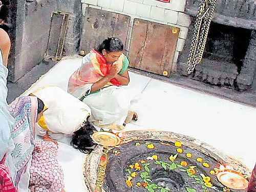 Three women offer prayers at the Trimbakeshwar temple in Nashik on Thursday. PTI