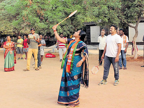 aiming high: BJP state vice-president Vanathi Srinivasan plays badminton during her poll campaign in Coimbatore. DH photo