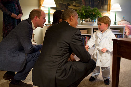Handout photo issued by Kensington Palace of Prince George (right) meeting the President of the United States Barack Obama (centre) and First Lady Michelle Obama (behind) at Kensington Palace, London. Reuters photo