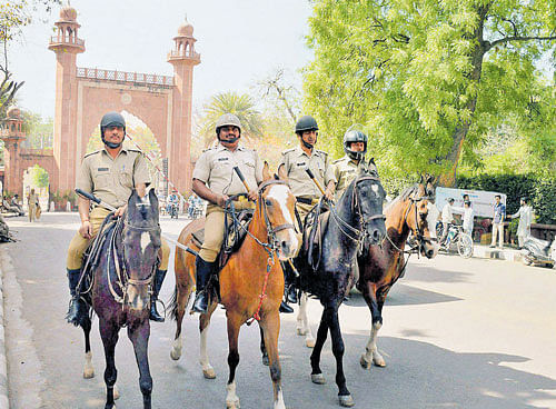 Police force deployed in front of Aligarh Muslim University gate after clashes between two groups at University campus, in Aligarh on Sunday. PTI