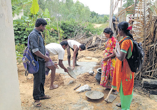 progress Women overseeing the construction of a lavatory in one of the villages in Malur taluk.