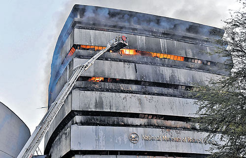 Fire fighters dousing a massive fire that broke out at Ficci Building, where the museum is housed, in New Delhi on Tuesday.