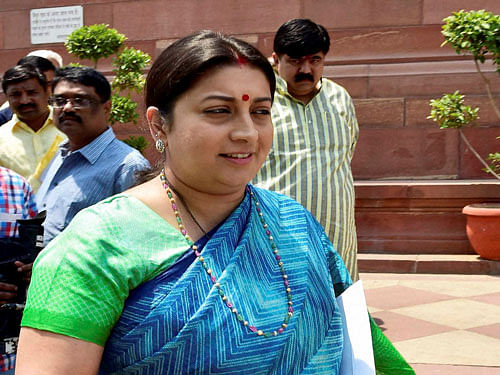 HRD Minister Smriti Irani comes out of Parliament in New Delhi on Thursday. PTI Photo.