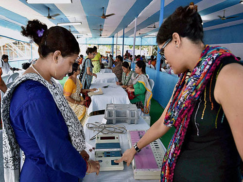 Women polling officers checking EVMs at distribution Center ahead of 5th phase assembly elections in Kolkata on Friday. PTI Photo.