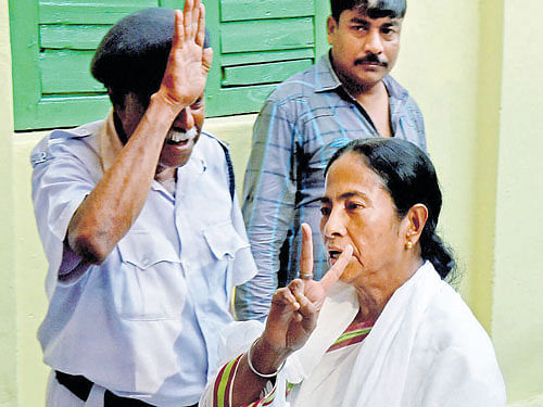 Premium votes: West Bengal Chief Minister and Trinamool supremo Mamata Banerjee shows victory sign after casting her vote at a polling station in south Kolkata on Saturday. PTI