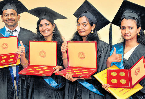 Ravi S C, winner of 6 gold medals, Amrutha Lakshmi M  and Dinta Sebastian, winners of 7 gold medals each and Pallavi H S, winner of 4 gold medals at the 50th convocation of University of Agricultural Sciences at GKVK in Bengaluru on Saturday. DH&#8200;Photo