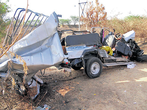 tragic: The mangled Land Cruiser which was crushed between two buses killing 10 persons near Heggere in Challakere taluk of Chitradurga district on Saturday. dh Photo