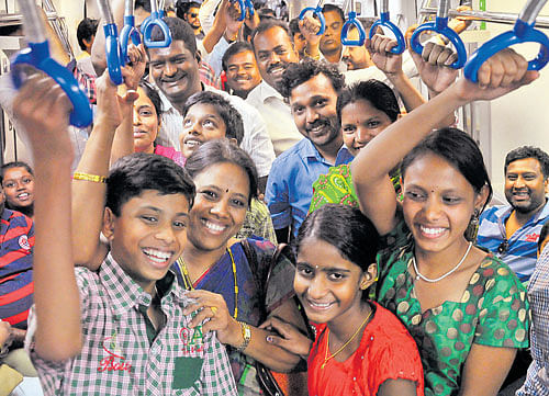 People enjoy a Metro ride at the Kempegowda station in Bengaluru on Saturday. DH Photo by B K Janardhan