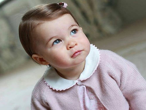 The new photographs show Charlotte wearing a blue collared dress with matching tights and white cardigan and a similar outfit in pink. Image courtesy Twitter.
