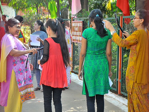 Security check for candidates who are attending CBSE All India Pre-Medical / Pre-Dental entrance examinations at Hebbal Kendriya Vidyalaya in Bengaluru on Sunday. DH Photo