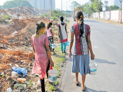 It's a daily ordeal for these girls to make a trip to the open toilet beside the railway track at Khatanagar in Jalahalli, with the scare of stalkers looming large. (Right) With no maintenance, the surroundings of this public toilet in the area have turned into a garbage dumping yard. dh photos