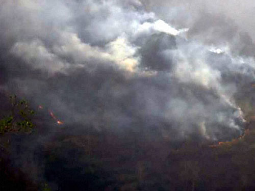 Smoke rises from forest fire in Yamkeshwa, Pauri Garhwal district in Uttarakhand on Sunday. PTI Photo