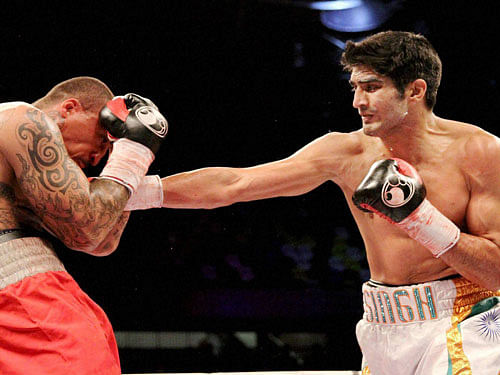Star Indian boxer Vijender Singh hits his French opponent Matiouze Royer at Manchester Arena, England on Saturday. This was Singh's fifth consecutive win. PTI Photo
