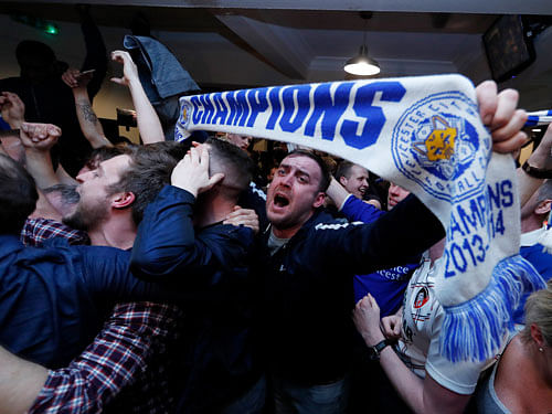 Leicester City fans watch the Chelsea v Tottenham Hotspur game in pub in Leicester - 2/5/16 Leicester City fans celebrate winning the Premier League.  Reuters