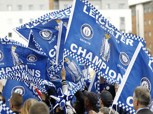 Leicester City fans celebrate with flags Action Images via Reuters.