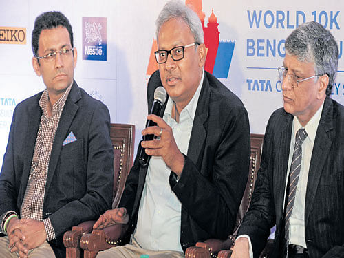 GEARING UP: Kapil Mohan (centre), Principal Secretary, Youth Service Department, addresses the gathering at the announcement of TCS World 10K event ambassador in Bengaluru on Tuesday. Nagraj Ijari (right) and Vishal  of TCS are also seen. DH PHOTO