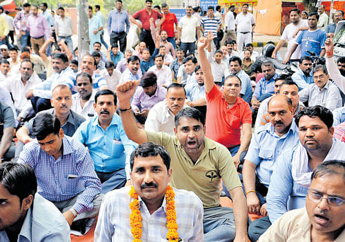 OUT&#8200;ON&#8200;STREETS: Taxi drivers shout slogans during a protest in New Delhi on Tuesday. DH photo/chaman gautam