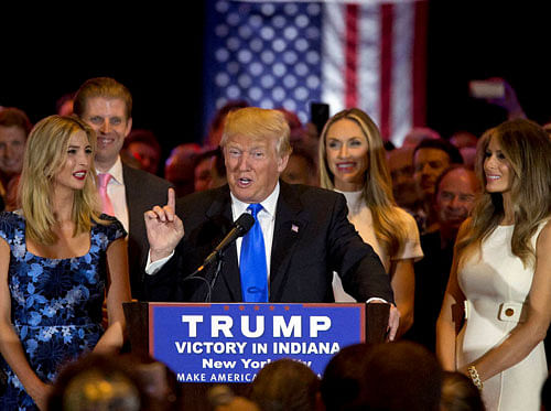 Republican presidential candidate Donald Trump is joined by his wife Melania, right, daughter Ivanka, left, and son Eric, background second from left, as he speaks during a primary night news conference, Tuesday, May 3, 2016, in New York. AP/PTI
