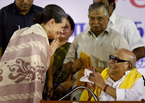 Poll tactics: DMK chief M Karunanidhi presents a shawl to Congress president Sonia Gandhi at an election rally at Island ground in Chennai on Thursday. PTI