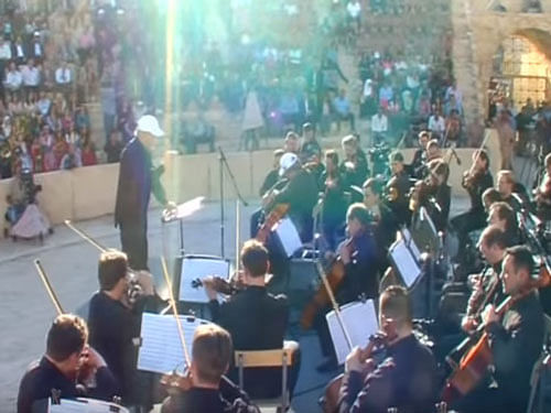 Famed conductor Valery Gergiev led Saint Petersburg's celebrated Mariinsky orchestra through pieces by Johann Sebastian Bach, Sergei Prokofiev and Rodion Shchedrin in front of a crowd of Russian soldiers, government ministers and journalists. Screen grab.