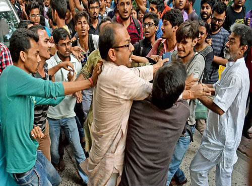ABVP activists clash with Jadavpur University Students who stopped the car of film director Vivek Agnihotri during their agitation against screening of his film 'Buddha in a Traffic Jam' at University campus in Kolkata on Friday. PTI Photo