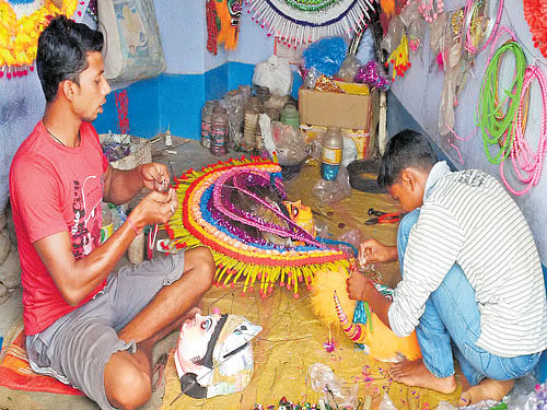 Mask makers at Charida village in Purulia engrossed in their work. Drimi Chaudhri