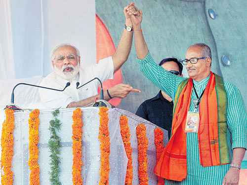 Prime Minister Narendra Modi introduces BJP candidate Sadanandan Master at an election campaign rally in Kasaragod on Sunday. PTI