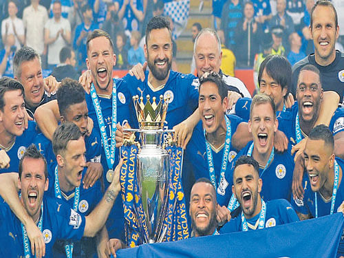 Leicester City players celebrate after being crowned the  champions of England.