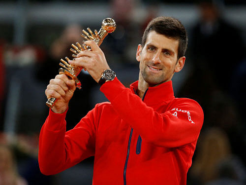 Djokovic holds up the trophy. Reuters Photo.