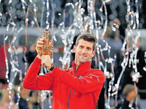 On top: Novak Djokovic with the Madrid Open title on&#8200;Sunday. Djokovic beat Andy Murray 6-2, 3-6, 6-3.  Reuters