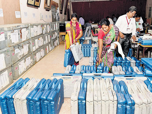 Polling officials check electronic voting machines at a distribution centre ahead of voting for Tamil Nadu Assembly polls, in Chennai on Tuesday. PTI