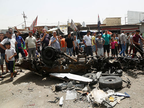 People gather at the scene of a car bomb attack in Baghdad's mainly Shi'ite district of Sadr City, Iraq, May 11, 2016. Reuters Photo.