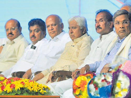Beneficiaries of government schemes take selfie with Chief Minister Siddaramaiah at Jana Mana, an interactive session organised as part of the Congress  government's third anniversary, on Friday. (Right)  Siddaramaiah and his Cabinet colleagues (from left) D K Shivakumar, T B Jayachandra, M B Patil,  S R Patil, H K Patil and K J George. DH&#8200;PHOTOS
