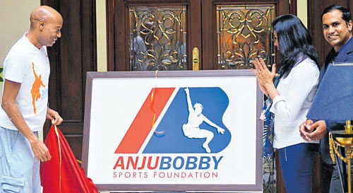 New beginning Mike Powell (left) unveils the logo of the Anju Bobby Sports Foundation on Saturday. DH photo