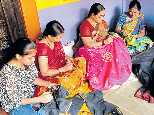 popular (Clockwise) A team of women in Dharwad stitching 'kasuti' designs; a 'teru' pattern; a close-up image of stitching work; a 'gopura' pattern. Photos by AUTHOR & M R Manjunath
