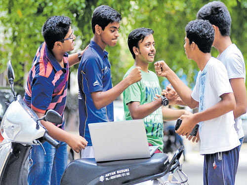 Students greet each other after knowing their SSLC results at Indiranagar on Monday. DH&#8200;Photo