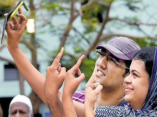 Voters take selfie after casting their votes in Chennai on Monday. PTI