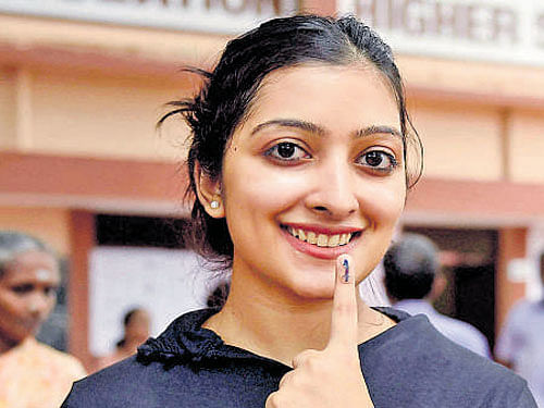 A first-time voter shows her ink marked finger in Chennai on Monday. PTI
