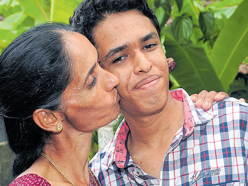 SSLC topper B S Ranjan gets a kiss from his mother Triveni after the results were announced on Monday. dh photo