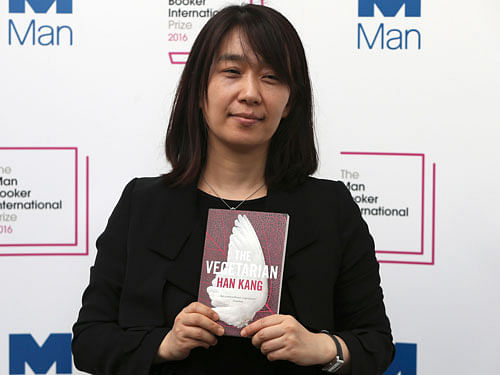 Nominated author Han Kang poses with her novel 'The Vegetarian', during a media event for the Man Booker International Prize 2016, in London, Britain May 15, 2016. REUTERS